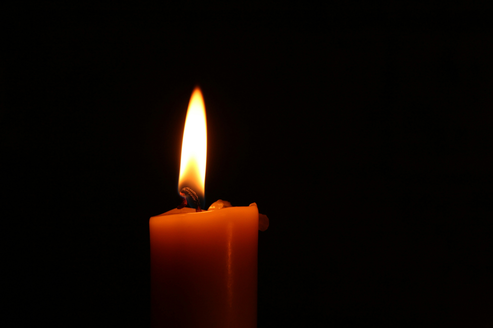 candle burning in darkness