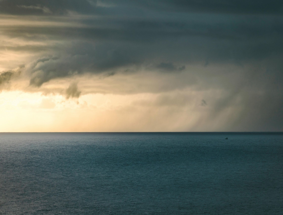 A stormy sky with sunset over the ocean