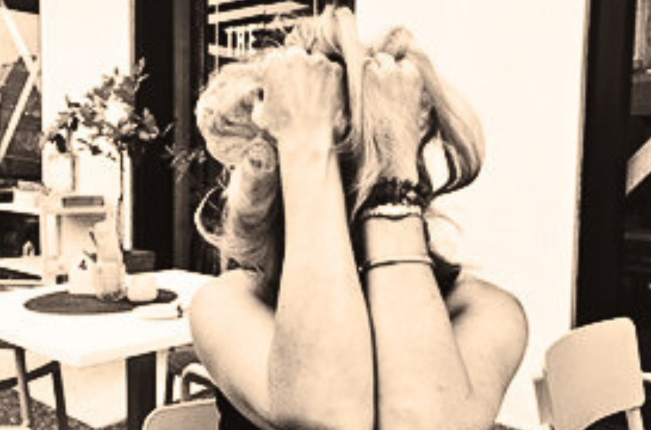 Woman with head in hands