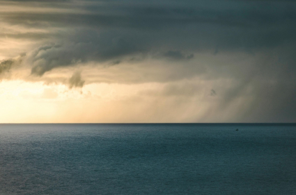 A stormy sky with sunset over the ocean