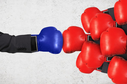 Person with boxing glove on punching several opponents.