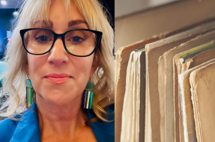Suzi next to a stack of files